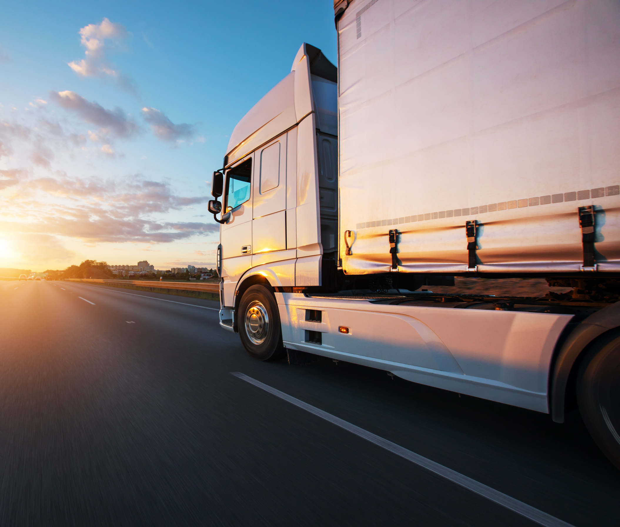 Loaded European truck on motorway in sunset